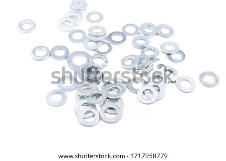 Metal washers on a white isolated background. Fasteners, close-up. Flat metal washers or spindle. Washers isolated on white