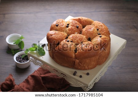 Chocolate Pull Apart Bread or Roti Sobek on a Cake Stand above Brown Wooden Table  Royalty-Free Stock Photo #1717985104