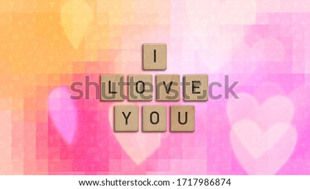 I love you written with wooden tiles over colorful background with heart shapes. This image can be used for a banner or a print postcard.