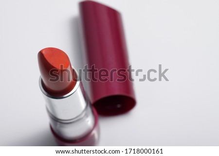 Close up shot of red lipstick on a white background
