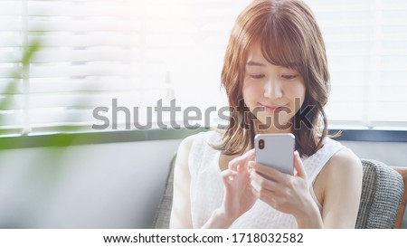 Young asian woman using a smart phone.