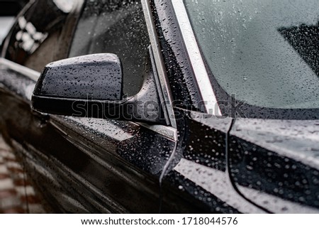 black stylish car in the rain
