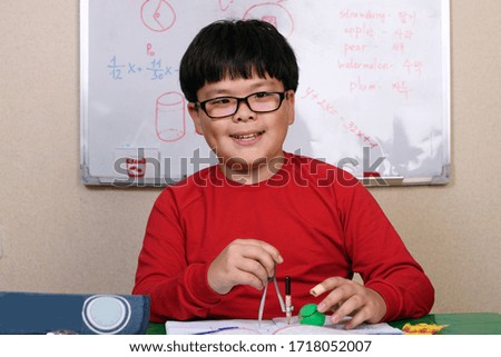 boy with glasses doing homework