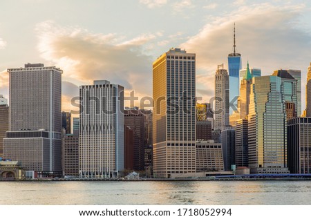 Lower Manhattan skyline at golden hour, view from Brooklyn Bridge Park