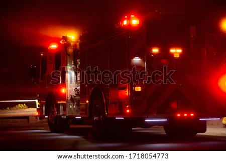 A fire engine responds to the scene of an emergency. Royalty-Free Stock Photo #1718054773