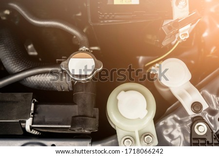 close up inside car engine mechanical parts, automobile parts in for service fixing repairing in workshop for professional mechanic inspection, wind screen fluid engine coolant, power steering fluid
