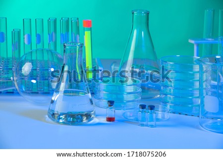 Vaious laboratory glassware with dramatic blue and green light