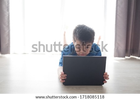 asian chinese boy playing tablet, addicted game and cartoon, 
