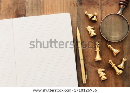 top view image of open notebook with blank pages on wooden table. ready for adding text or mockup