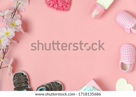 Top view aerial image of decoration Happy mothers day text holiday background concept.Flat lay gift box with baby shoes and love shape flower on modern beautiful pink paper.copy space for design.