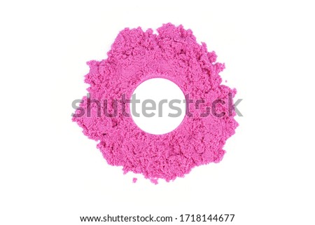 Kinetic sand of pink color on an isolated white background. Sand for children's creativity, leisure or psychological therapy.