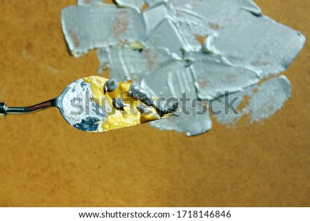 Palette knife with gold and silver paint. Abstract art concept. Drawing, art concept.