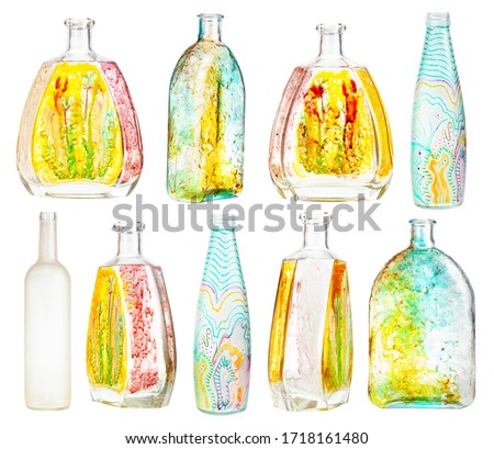 set of various hand painted glass bottles isolated on white background