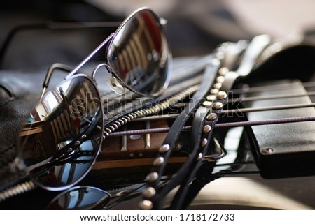 Black leather, rivets, a guitar and sunglasses are all symbols of rock. Royalty-Free Stock Photo #1718172733