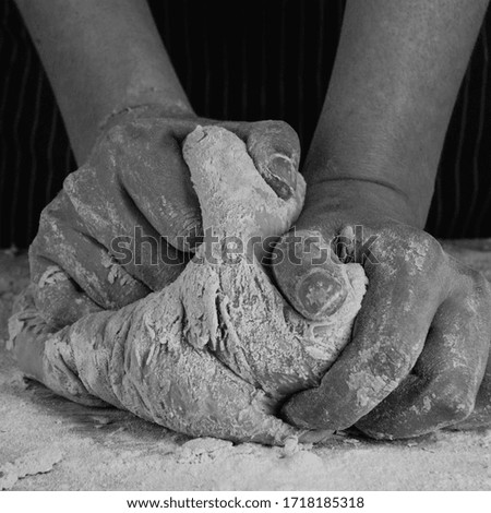 female hands knead the dough black and white photo