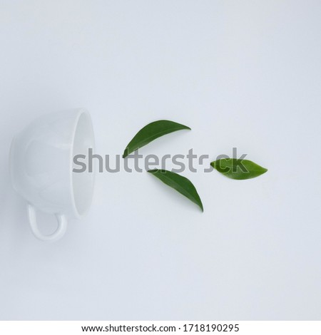 cup with tea and teapot on white background, over light
