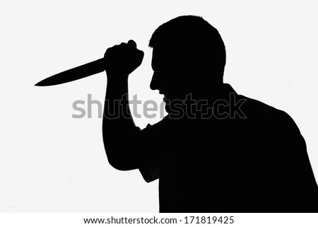 Killer man holding knife in hand. Silhouette picture