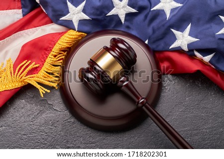 Top view of wooden judge gavel on background of American flag on black background Royalty-Free Stock Photo #1718202301