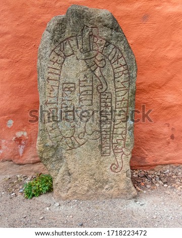 Runeston with  rune text  
Translation:Toki (name) the Viking, raised the stone in memory of Gunnar (name), Grimrs (name) son. May God help his soul!