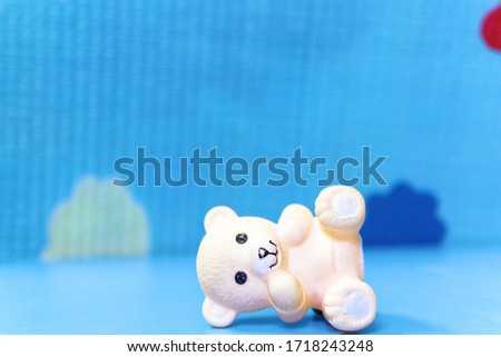 Teddy Bear rubber toy in blue background of shallow Dof with copy space 