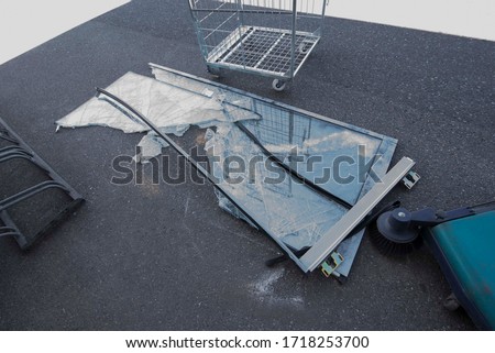 glass breakage in front of a building Royalty-Free Stock Photo #1718253700