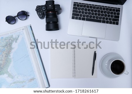 Travel preparations, map, camera, notebook and cup of coffee on white background. Top view, flat lay
