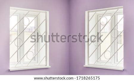 room corner with bright purple wall and modern plastic windows behind diagonal grilles against street close view