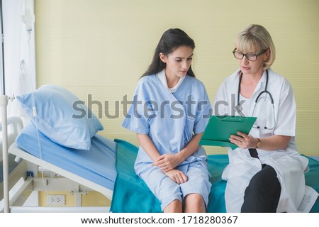 Senior female doctor meet the patient discussing consultation and making notes about symptom problem. Health care and client service in medicine concept.