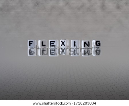 flexing dance style concept represented by black and white letter cubes on a grey horizon background stretching to infinity