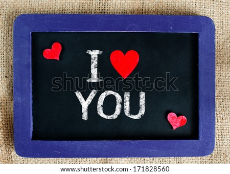 I love you with heart on a cloth background on small blackboard