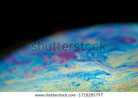 Abstract background wallpaper soap bubble sphere with iridescent texture. Rainbow waves on the surface