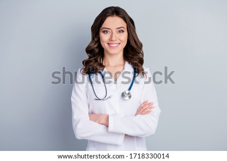 Photo of attractive family doc lady patients consultation beaming friendly smiling reliable virology clinic arms crossed wear white lab coat stethoscope isolated grey color background Royalty-Free Stock Photo #1718330014