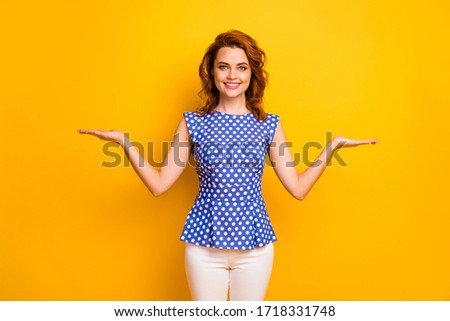 Portrait of her she nice attractive lovely cheerful cheery wavy-haired girl holding on palms surprise present gift deciding isolated on bright vivid shine vibrant yellow color background