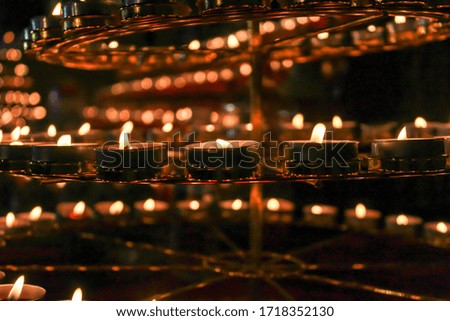 Row of candles with blurred candles background