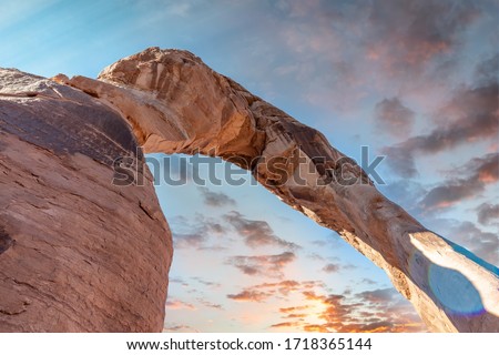 Skyward view of Delicate Arch, Arches National Park. Rock formation and blue sky, USA