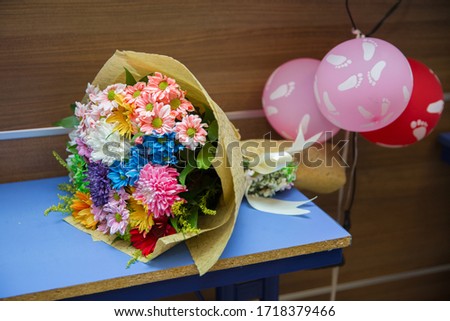multi-colored bouquet of yellow on top. A bouquet of flowers on the table.Rainbow Daisies. Chrysanthemum Rainbow Flower. Bouquets of blossom rainbow Chrysanthemum
