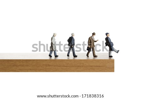 Business figurines walking off a ledge  Royalty-Free Stock Photo #171838316