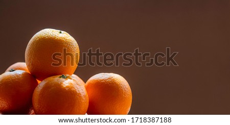 Many oranges on brown background with copy space 