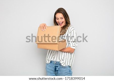 single woman reciving an order that si did online, ecommerce is the new business, happy to do shopping from home. Reciving or sending goods with delivery company. Happy client that recive her percel Royalty-Free Stock Photo #1718399014