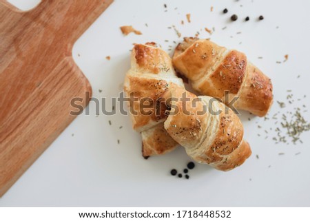 Homemade puff on the white table. Croissant with cheese and meat
