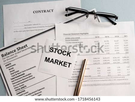 STOCK MARKET text on white paper and glasses on documents