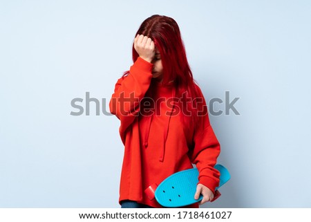 Teenager skater girl isolated on white background with headache