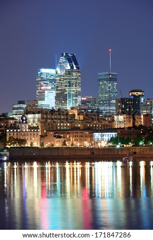 Montreal over river at dusk with city lights and urban buildings