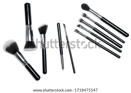 Make-up brushes isolated over white background. Professional makeup paintbrush. Natural and synthetic bristles, black handles and elegant looking make up artist tools. Royalty-Free Stock Photo #1718475547