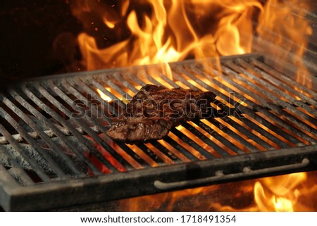 a slice of steak denver grill on fire
