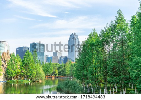 The city park under the blue sky. There is central business district in the distant.  This photo was taken in Yinzhou, Ningbo, Zhejiang, China.