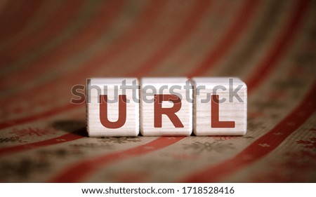 URL - concept on wooden cubes on a striped background