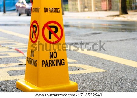 Plastic yellow cones forbidding parking nearby