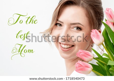 Portrait of beautiful woman with pink tulips on white background with text To The Best Mom.