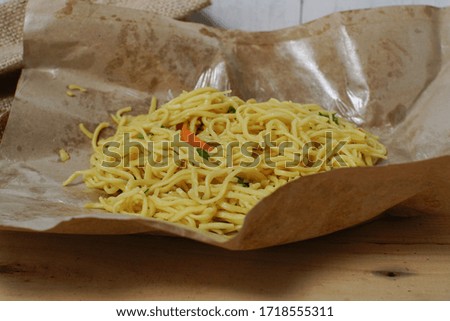 close up yellow noodles using oil paper pads.